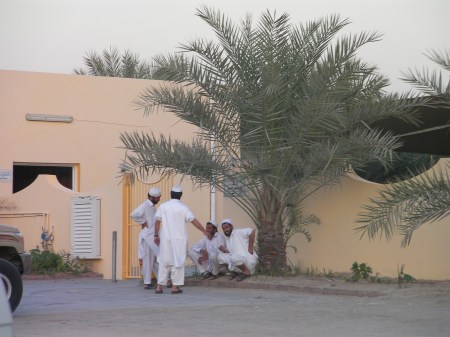 four men outside a mosque