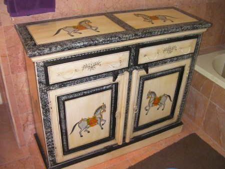cabinet painted with ponies on it