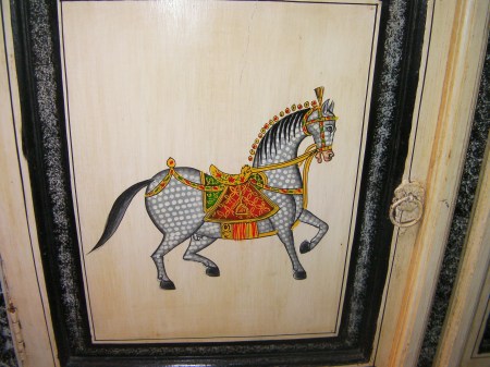 close up of pony painted on cabinet