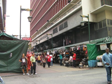 booths lining the street selling cheap handbags and sunglasses