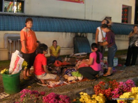 women selling piles of bras