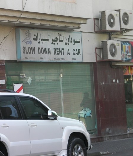 Slow Down Rent a Car sign