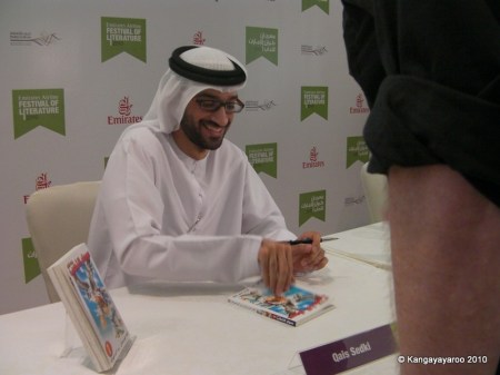 Qais Sedki, author, signing a book