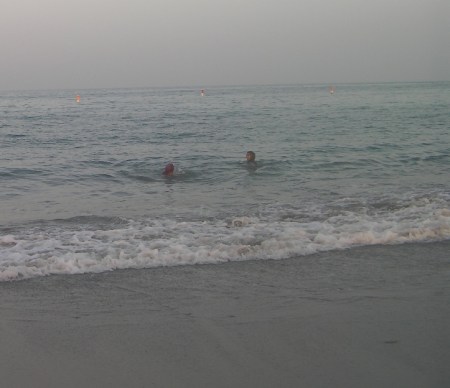 Swimmers two girls swimming in the surf
