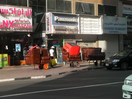 Moving carts loaded with living room furniture