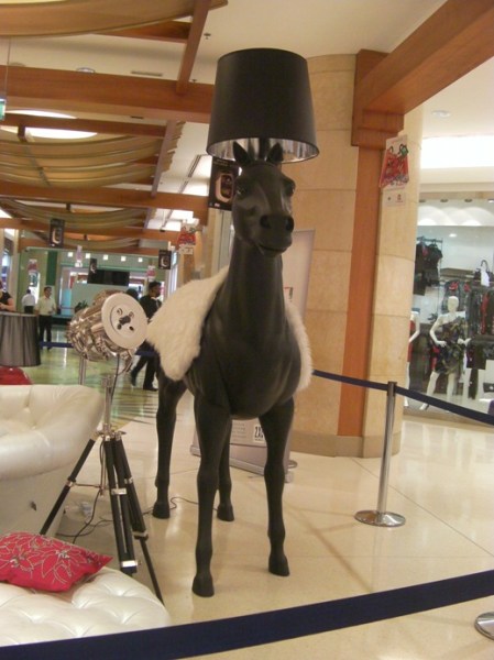 a life-size horse statue with a lamp coming out of it's head