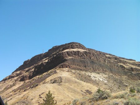 Fortress rugged hill with layers of volcanic rock formations