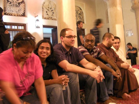 six people sitting on pillows
