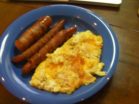 Finished Product finished bacon wrapped sausage with scrambled cheesy eggs