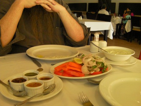 Condiments small bowls of sauces, plate of cut vegetables, bowl of yogurt