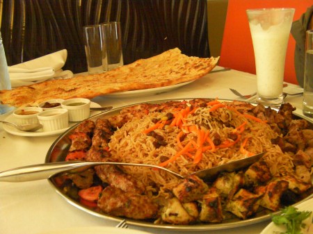 Some of everything platter filled with rice and several types of grilled meat