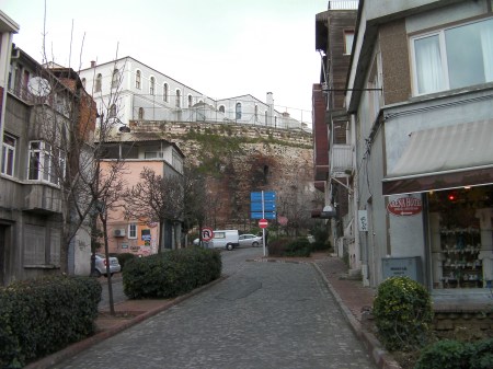 modern street ending at an ancient wall