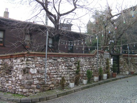 wooden house with a stone fence