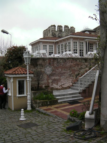 a cafe built on ancient stone wall and backed by stone wall