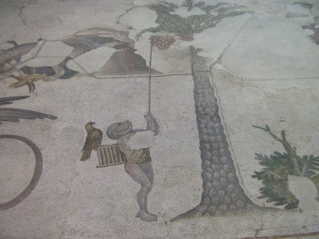 mosaic monkey with stick attempting to catch birds in a tree