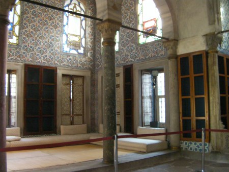inside library building, blue tiled walls and stained glass windows