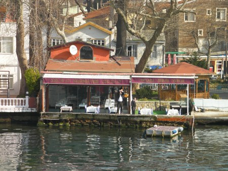 Restaurant Hawker man standing on the edge of a shoreline restaurant
