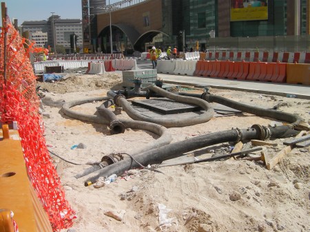 The Pipe Ends Here large black pipes that circle & attach to each other
