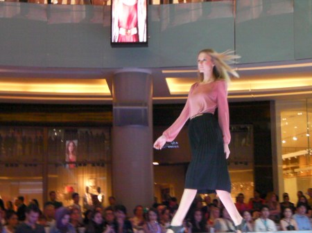 pink blouse and black pleated skirt