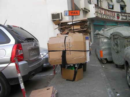 cart loaded with flattened cardboard boxes