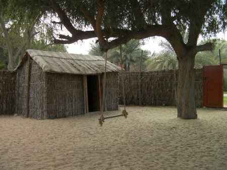 hut and fence made out of palm fronds