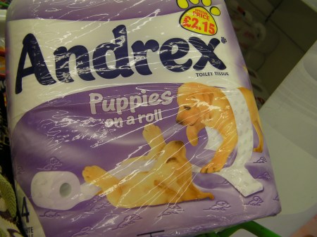 toilet paper package stating "puppies on a roll"