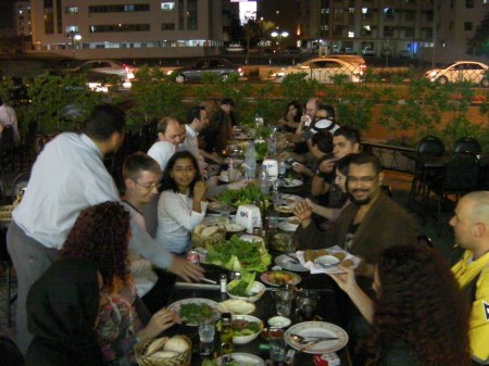 DaddyBird's 48th Birthday crowd of people at a table full of food