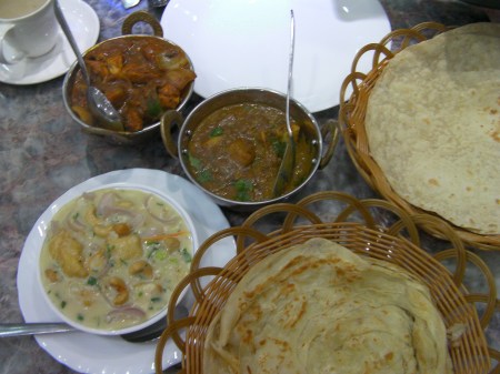 three dishes and flat bread