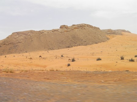 Road to Kalba rock formations rising up out of sand dunes