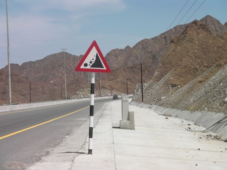 Falling Rocks falling rocks warning sign, mountains in the background