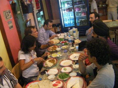 several people at table full of foood