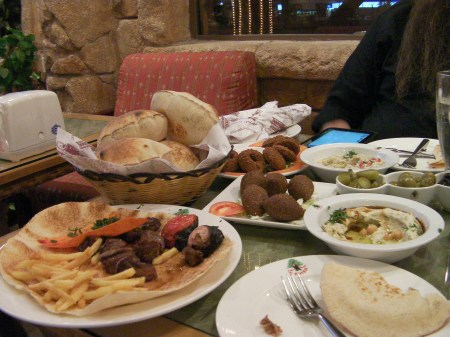 Dinner food including kabab, hommus, kebbeh, falafel