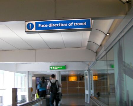 Face Direction of Travel sign stating face direction of travel