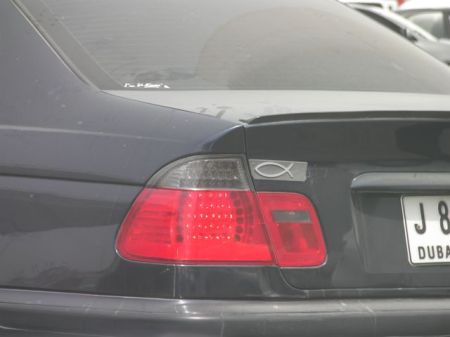 Christian fish symbol on the back of a car