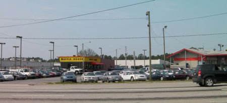 Waffle House restaurant befind a used car lot