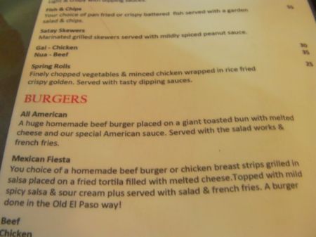 menu description of the burger as huge patty on giant bun