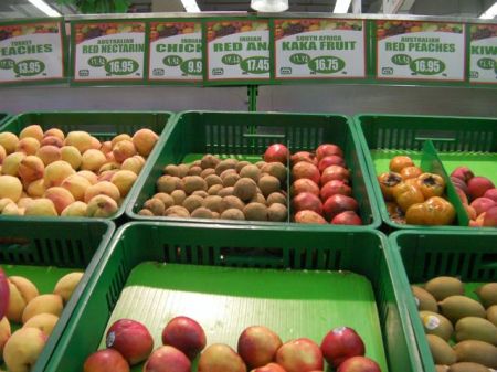 grocery fruit section with sign for "kaka fruit"
