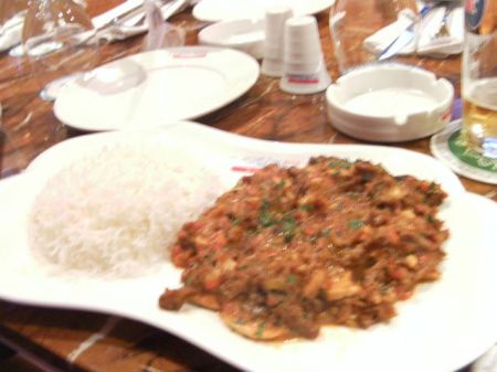 plate of white rice and meat in red sauce