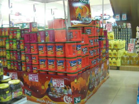 store display of stacked large containers of Tang drink mix