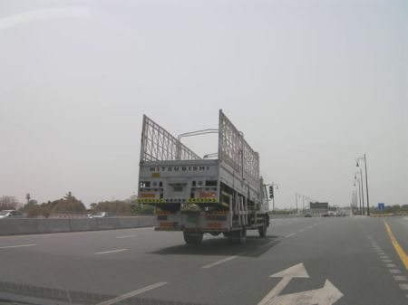 a truck hauling another truck bed