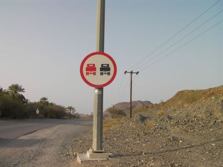 Red Truck Black Truck road sign with a red truck and a black truck