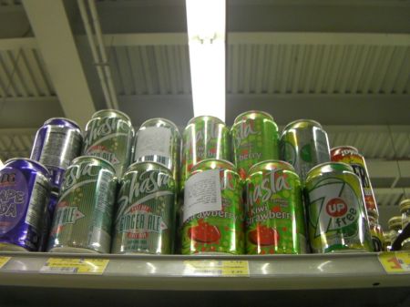 cans on top grocery shelf 