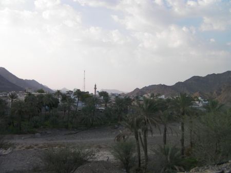 Bithnah Fort 2 city at the far side of a dry river bed