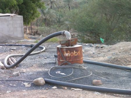 Bithnah Fort 7 old rusted Mobil oil barrel that is now part of a water well
