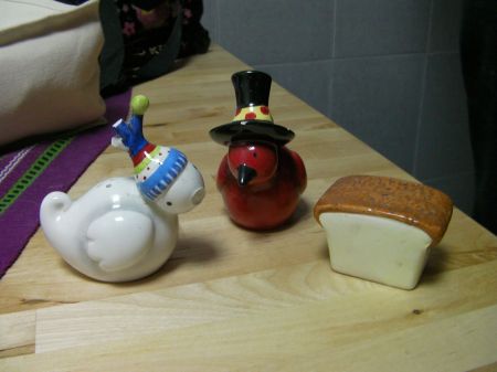 salt and pepper shakers shaped like birds and a salt shaker shaped like a slice of bread