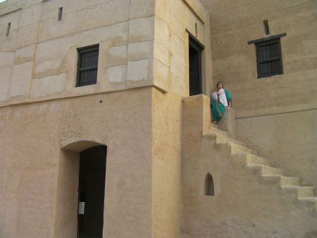 woman sitting at the top of the stairs