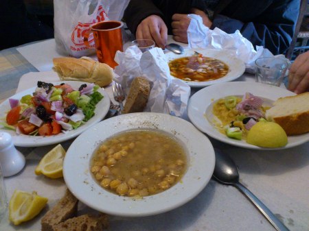 Lunch four bowls of food, salad, chickpeas, large bean soup, fava bean paste