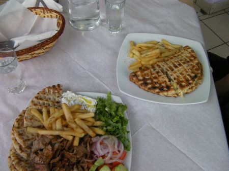 Souvlaki Lunch two plates full of grilled meat, fries, bread, salad