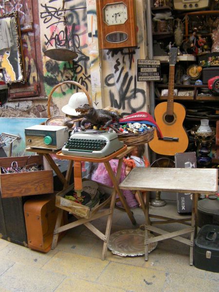 Flea Market store offering a stuffed aligator, guitar, typewriter, and a variety of other odds and ends
