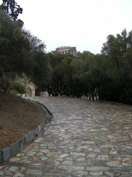 Climb to the Acropolis stone walkway uphill with Parthenon in the distance